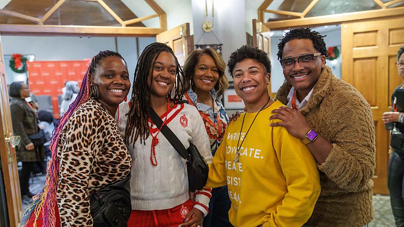 A group of attendees standing together and smiling during a break at the Summit.